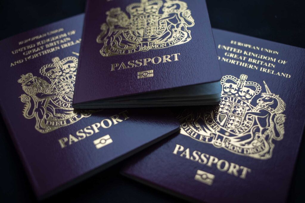 three British passports on a black bacground